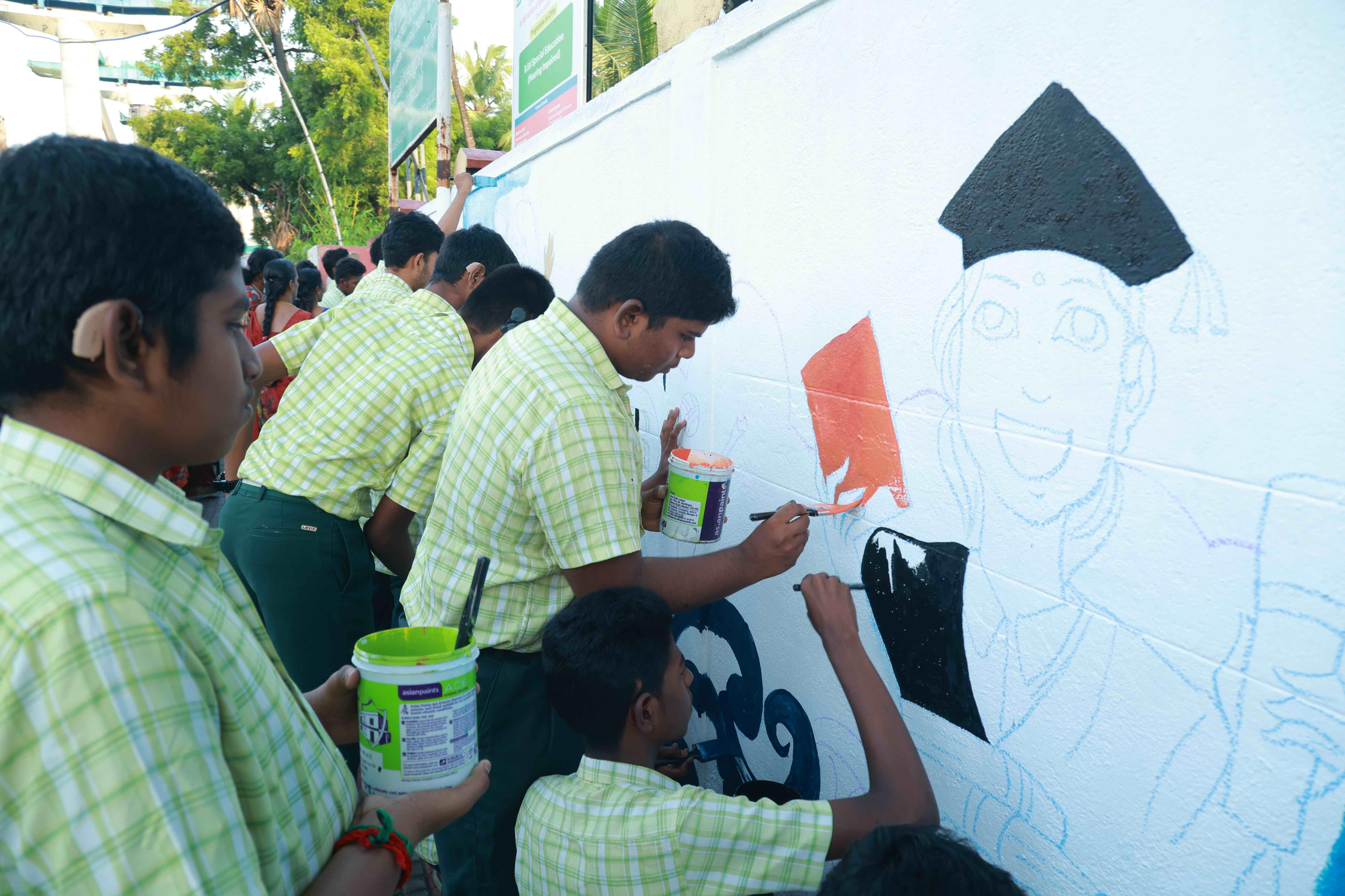 DRAW PICTURES ON A 72-INCH-HIGH AND 360-INCH-WIDE COMPOUND WALL WITHIN 2 HOURS AND 30 MINUTES BY 106 DEAF AND HARD-OF-HEARING CHILDREN.