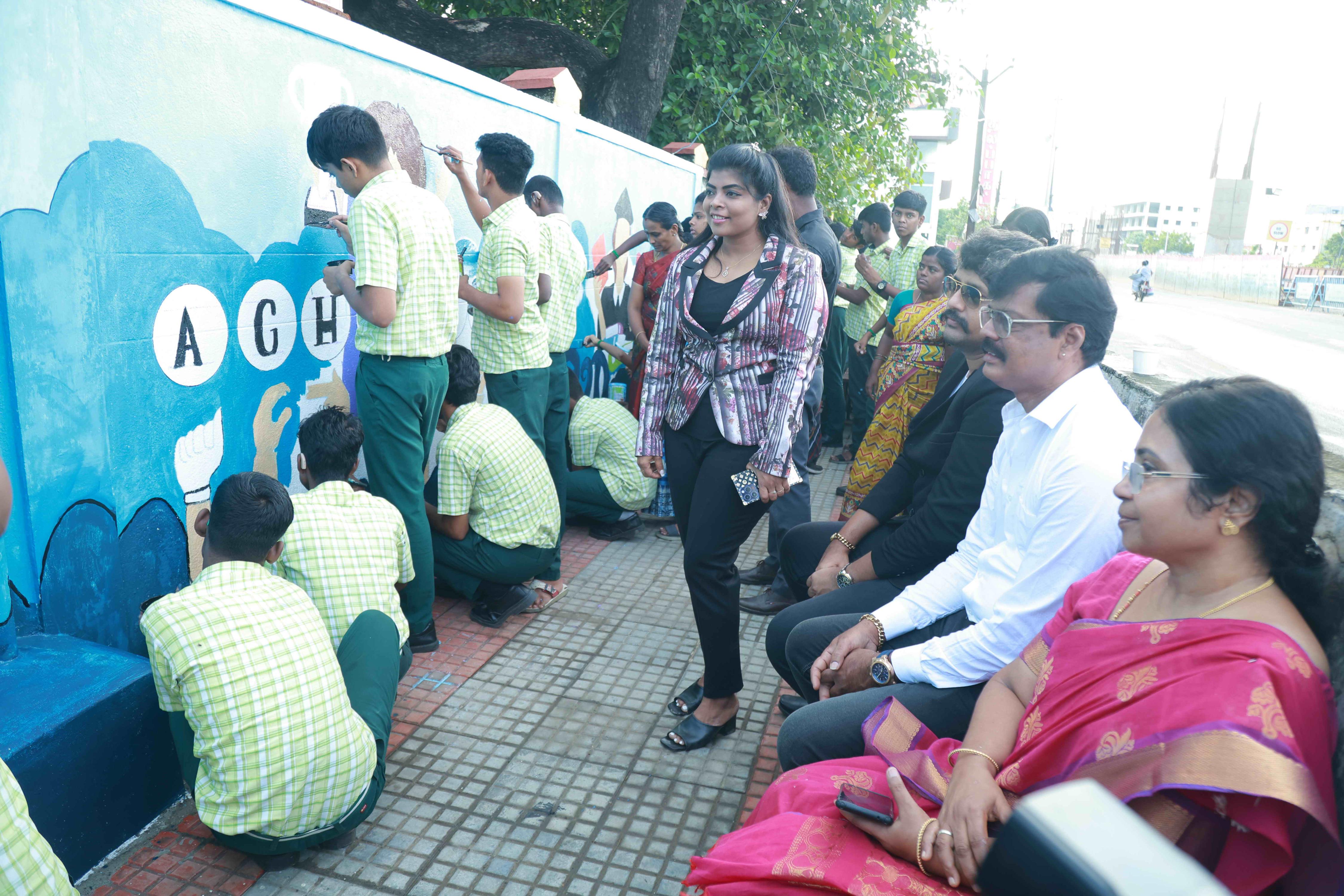 DRAW PICTURES ON A 72-INCH-HIGH AND 360-INCH-WIDE COMPOUND WALL WITHIN 2 HOURS AND 30 MINUTES BY 106 DEAF AND HARD-OF-HEARING CHILDREN.