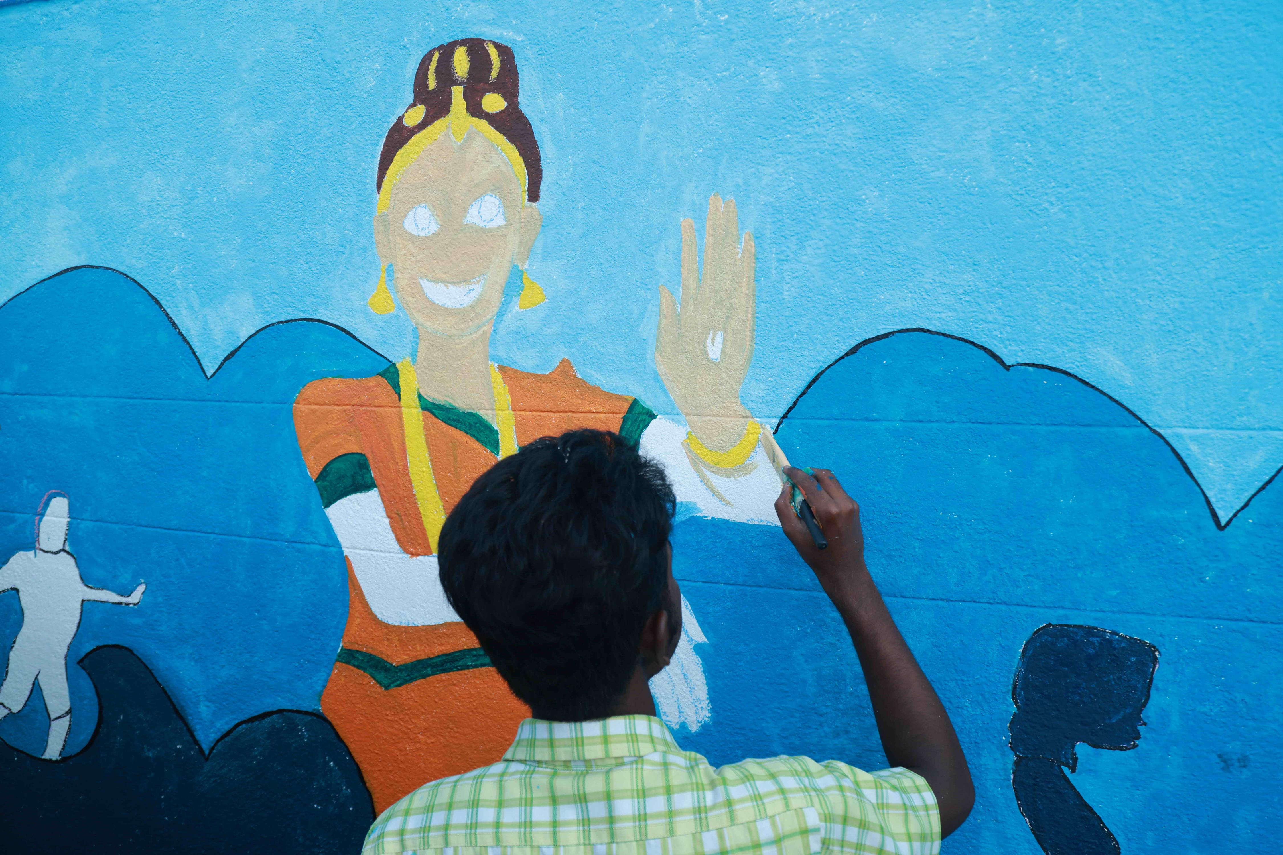 DRAW PICTURES ON A 72-INCH-HIGH AND 360-INCH-WIDE COMPOUND WALL WITHIN 2 HOURS AND 30 MINUTES BY 106 DEAF AND HARD-OF-HEARING CHILDREN.