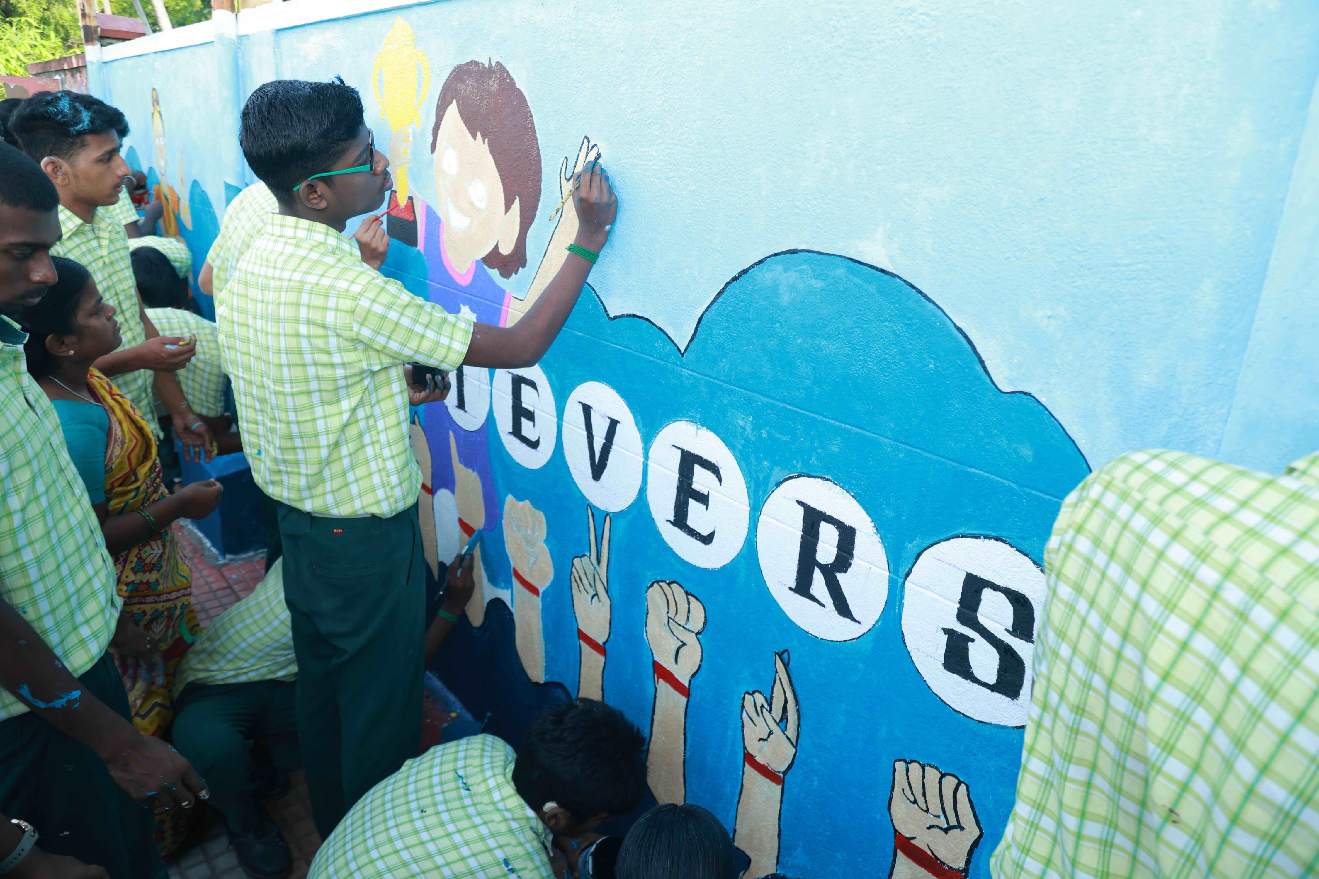 DRAW PICTURES ON A 72-INCH-HIGH AND 360-INCH-WIDE COMPOUND WALL WITHIN 2 HOURS AND 30 MINUTES BY 106 DEAF AND HARD-OF-HEARING CHILDREN.