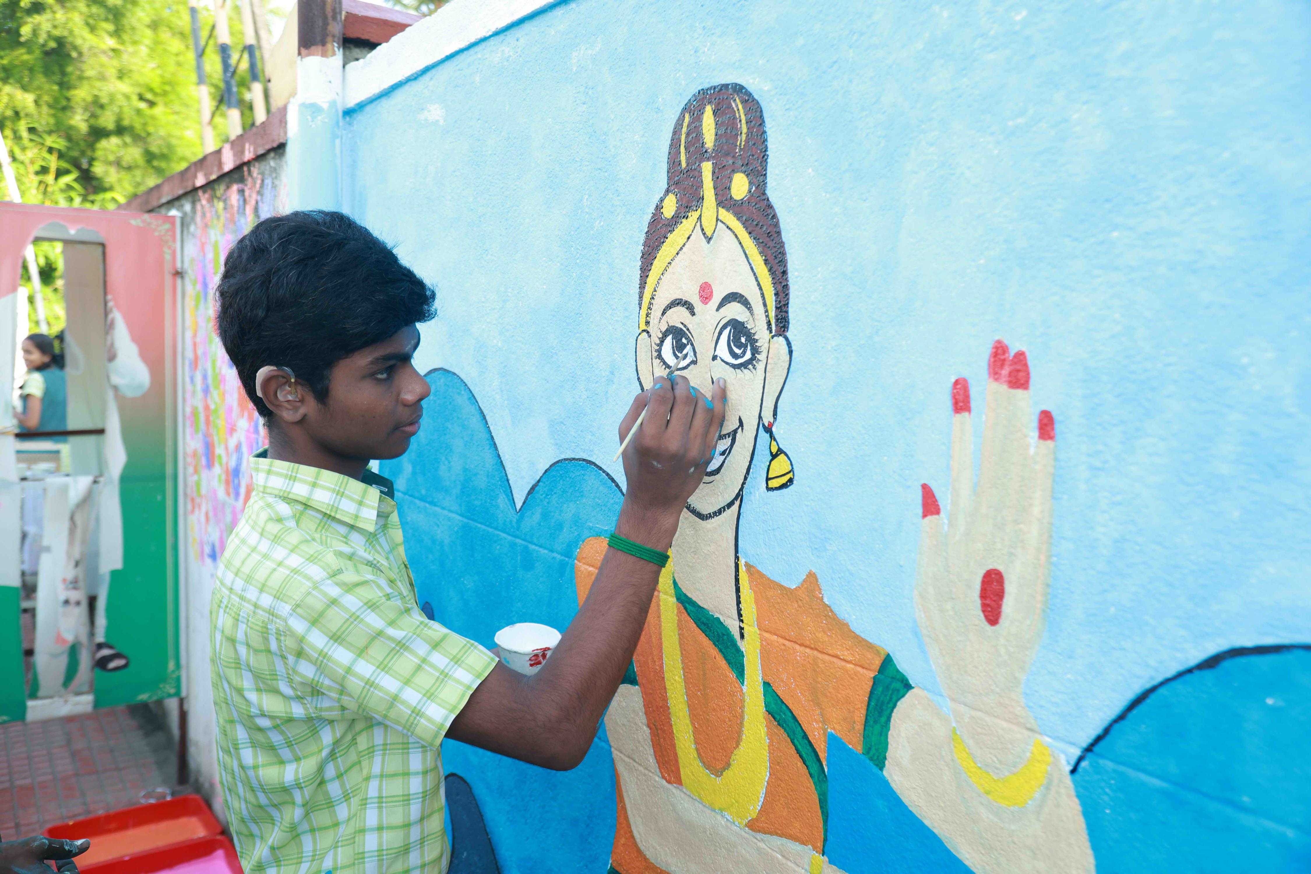 DRAW PICTURES ON A 72-INCH-HIGH AND 360-INCH-WIDE COMPOUND WALL WITHIN 2 HOURS AND 30 MINUTES BY 106 DEAF AND HARD-OF-HEARING CHILDREN.