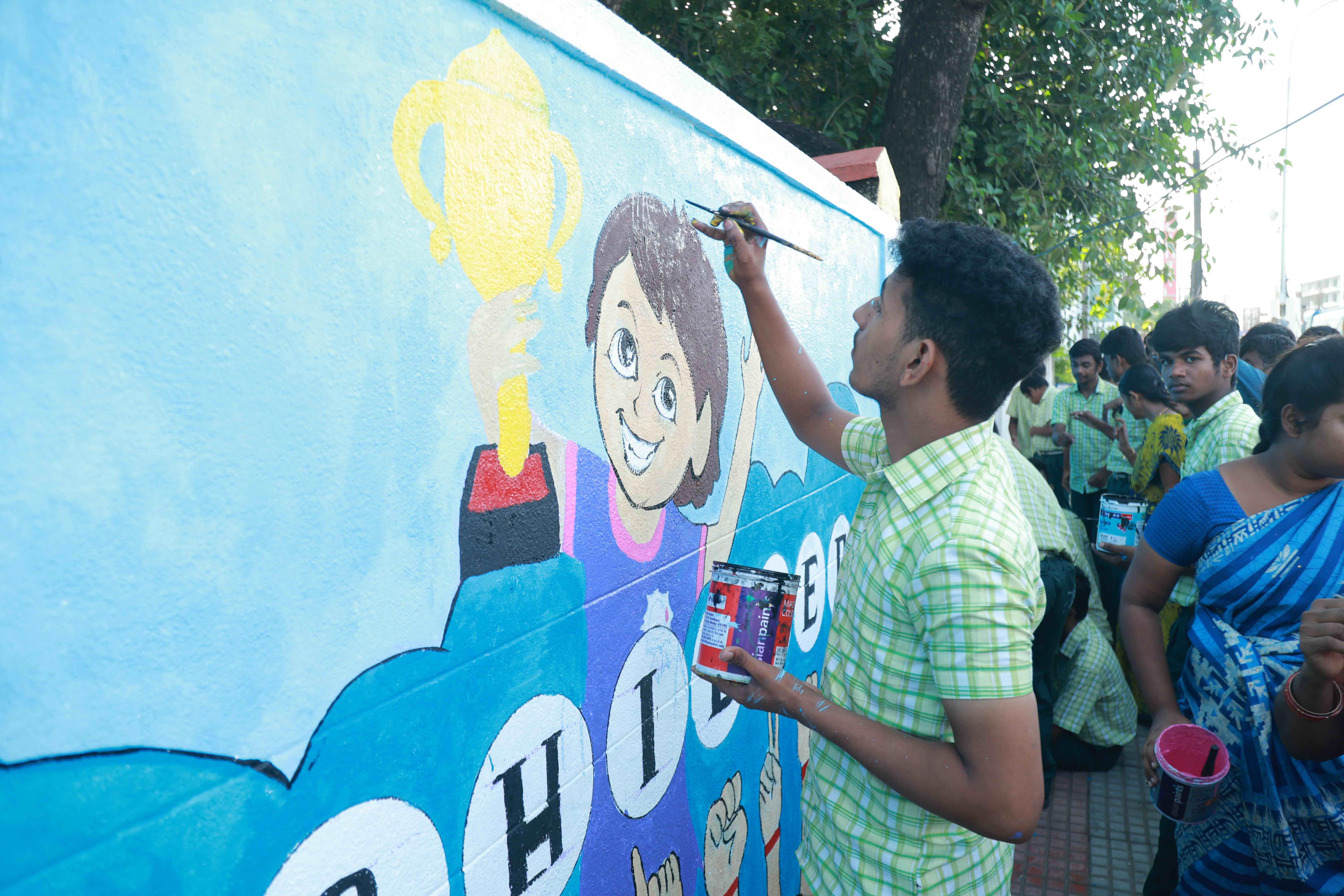 DRAW PICTURES ON A 72-INCH-HIGH AND 360-INCH-WIDE COMPOUND WALL WITHIN 2 HOURS AND 30 MINUTES BY 106 DEAF AND HARD-OF-HEARING CHILDREN.