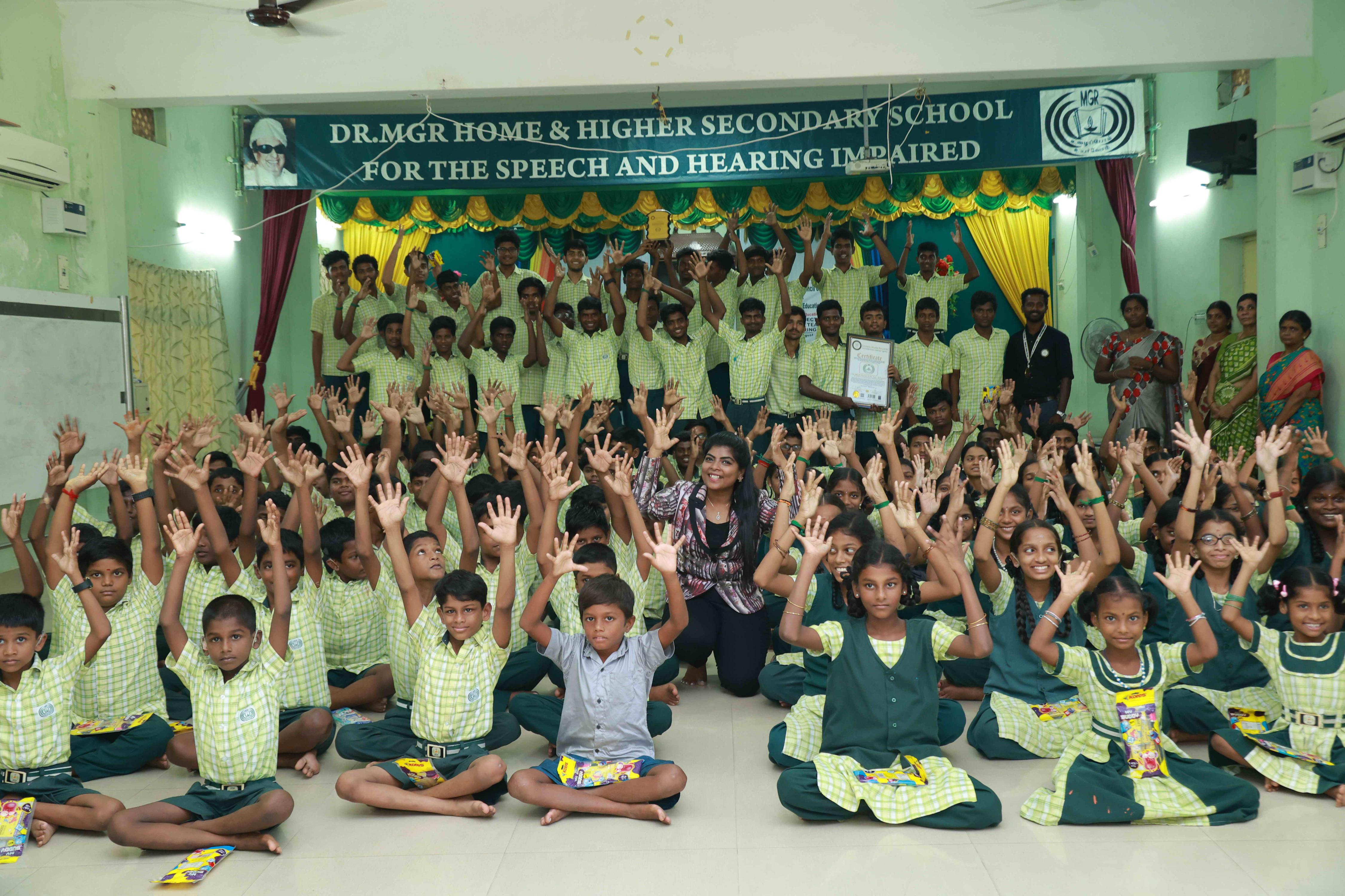 DRAW PICTURES ON A 72-INCH-HIGH AND 360-INCH-WIDE COMPOUND WALL WITHIN 2 HOURS AND 30 MINUTES BY 106 DEAF AND HARD-OF-HEARING CHILDREN.